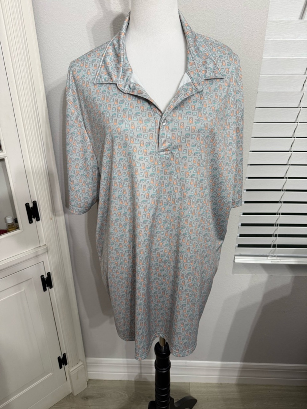 Huk Light Blue Polo Shirt with Coral and Teal Motif